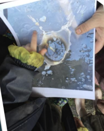 A photo of a child pointing at ripples in a photo of a rock splash.