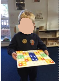 A child showing a pattern they had made from Numicon pieces