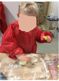 A child cutting playdough