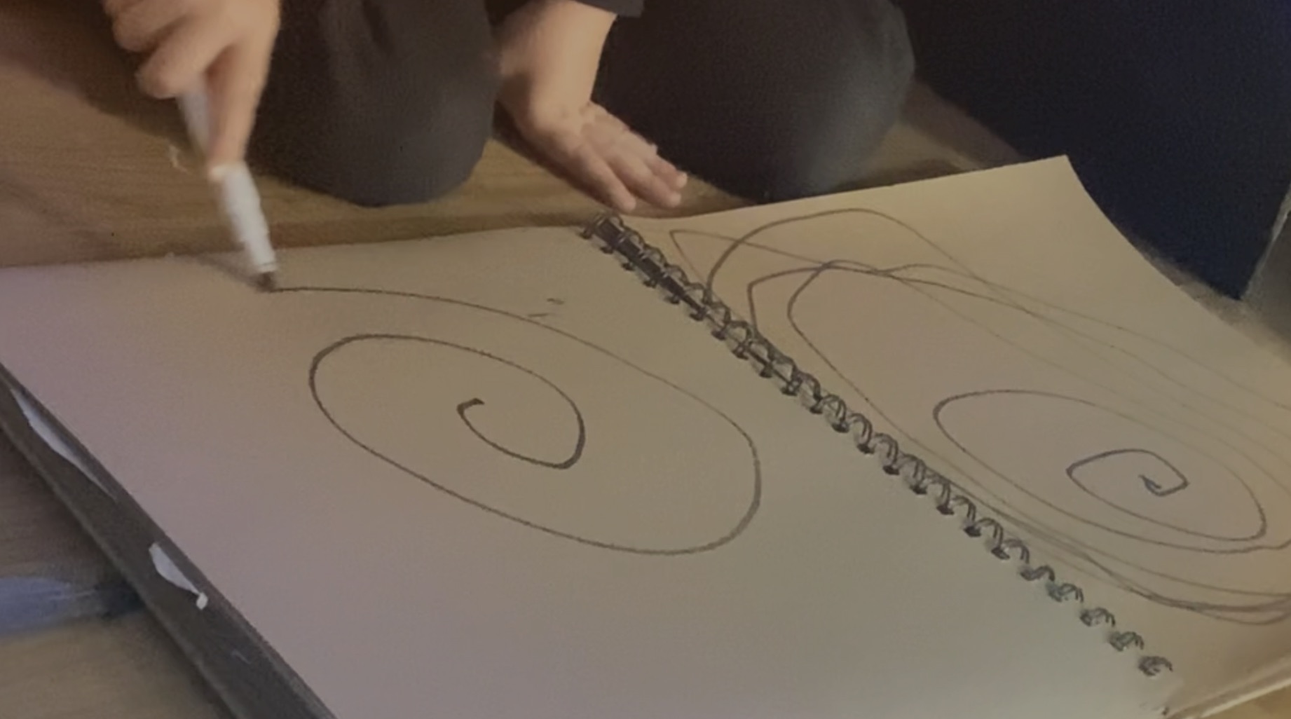 A child drawing spirals.